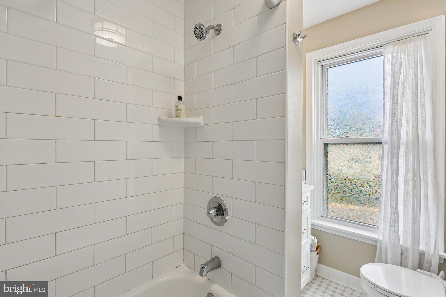 30 Hamilton Avenue Frederick, MD 21701 - Photo 19 of 38 Bright and airy bathroom with modern tiles.