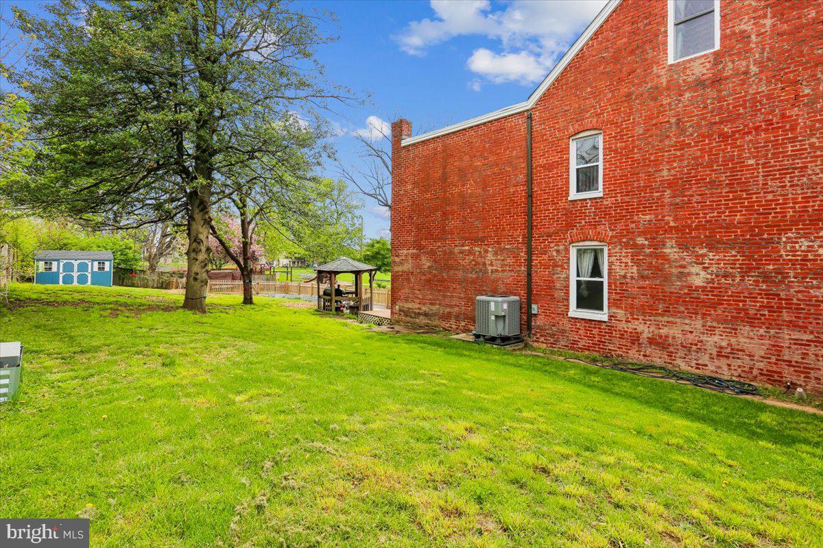 30 Hamilton Avenue Frederick, MD 21701 - Photo 35 of 37 a brick building with a yard