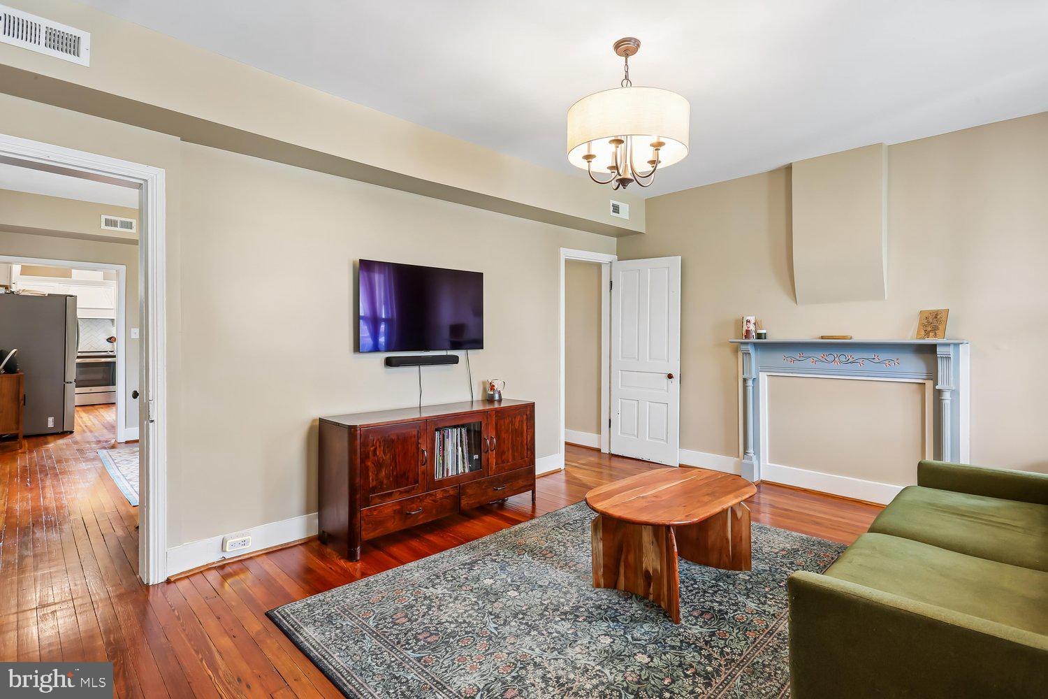 30 Hamilton Avenue Frederick, MD 21701 - Photo 6 of 37 a living room with furniture a flat screen tv and kitchen view