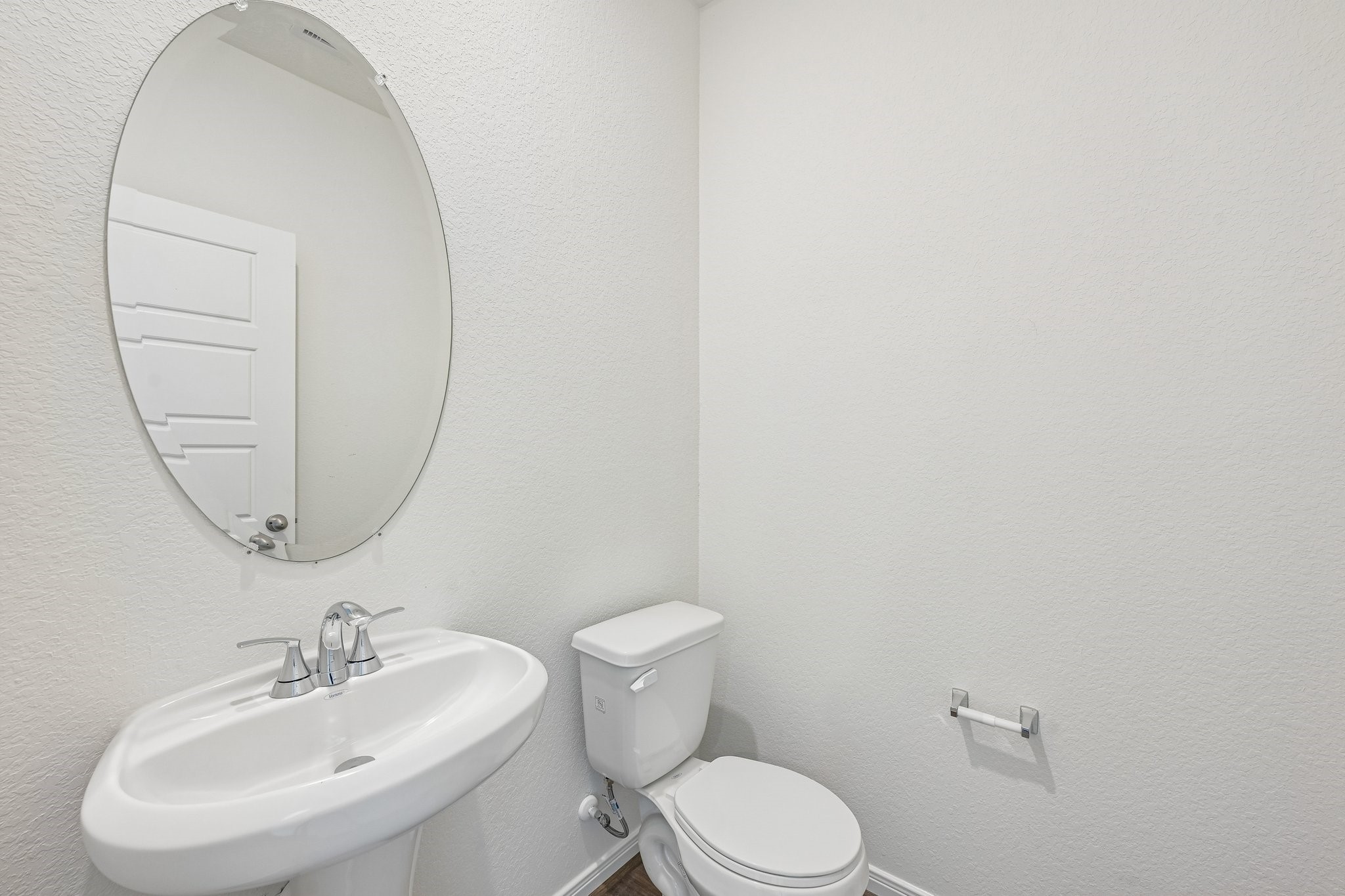 2503 Spruce Hl Road Beasley, TX 77417 - Photo 6 of 25 The powder room on the first floor includes a pedestal sink, oval mirror, and toilet to conveniently meet your needs.
