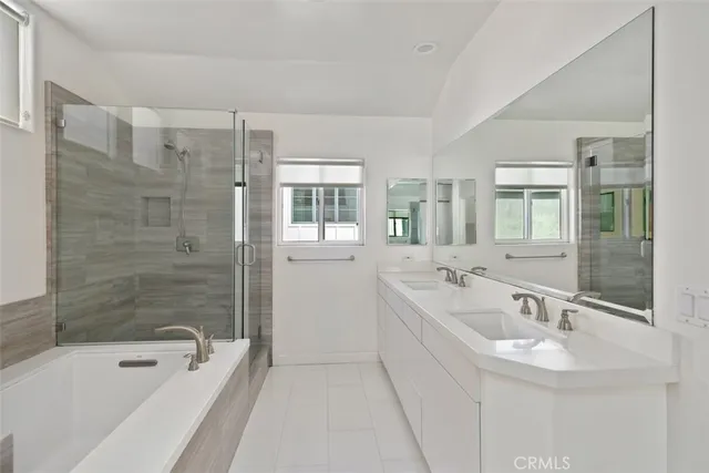 a bathroom with a bath tub a sink and mirror