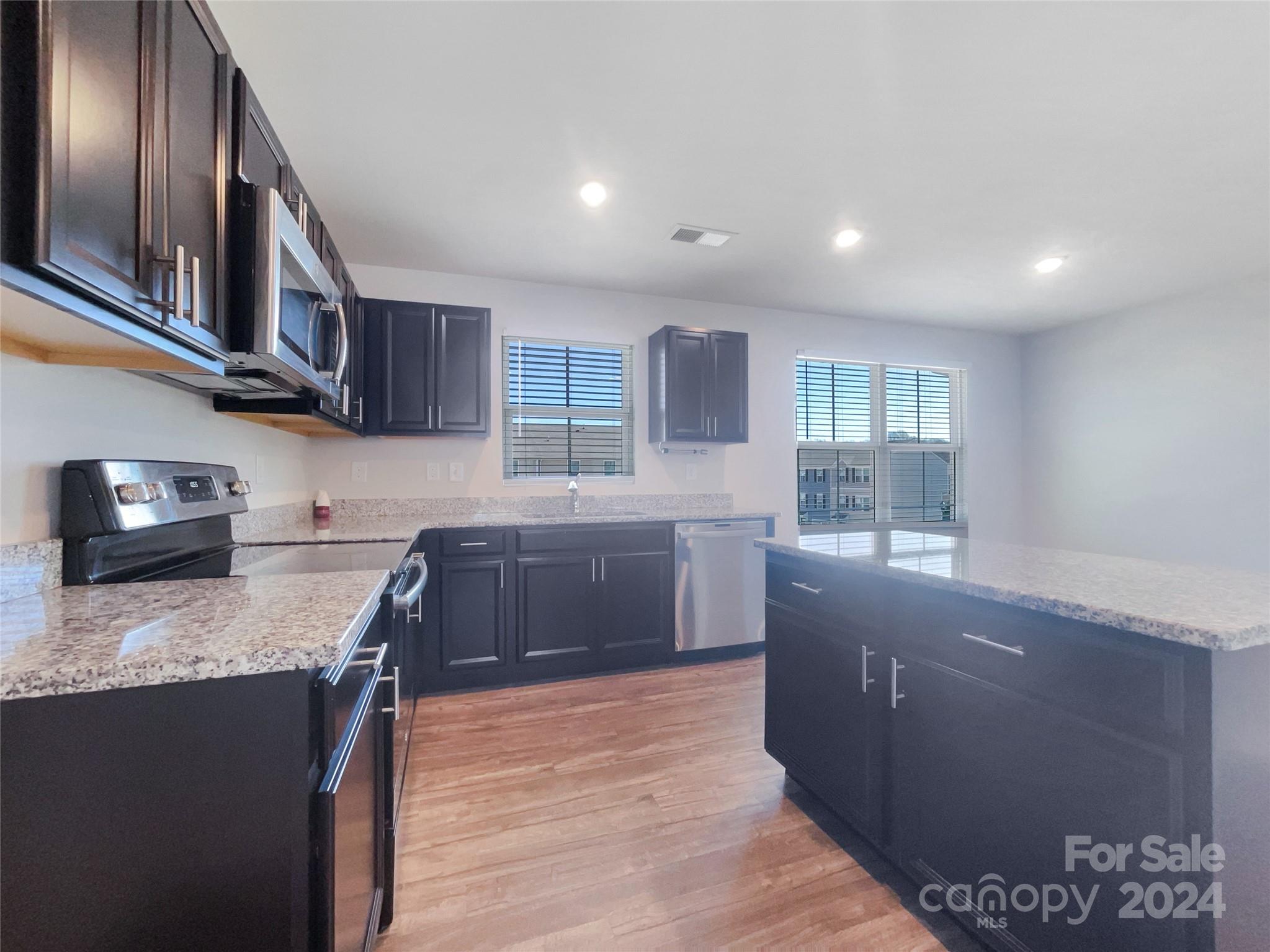 708 Dillon Way Fort Mill, SC 29715 - Photo 12 of 19 a kitchen with stainless steel appliances granite countertop a sink stove and granite counter top