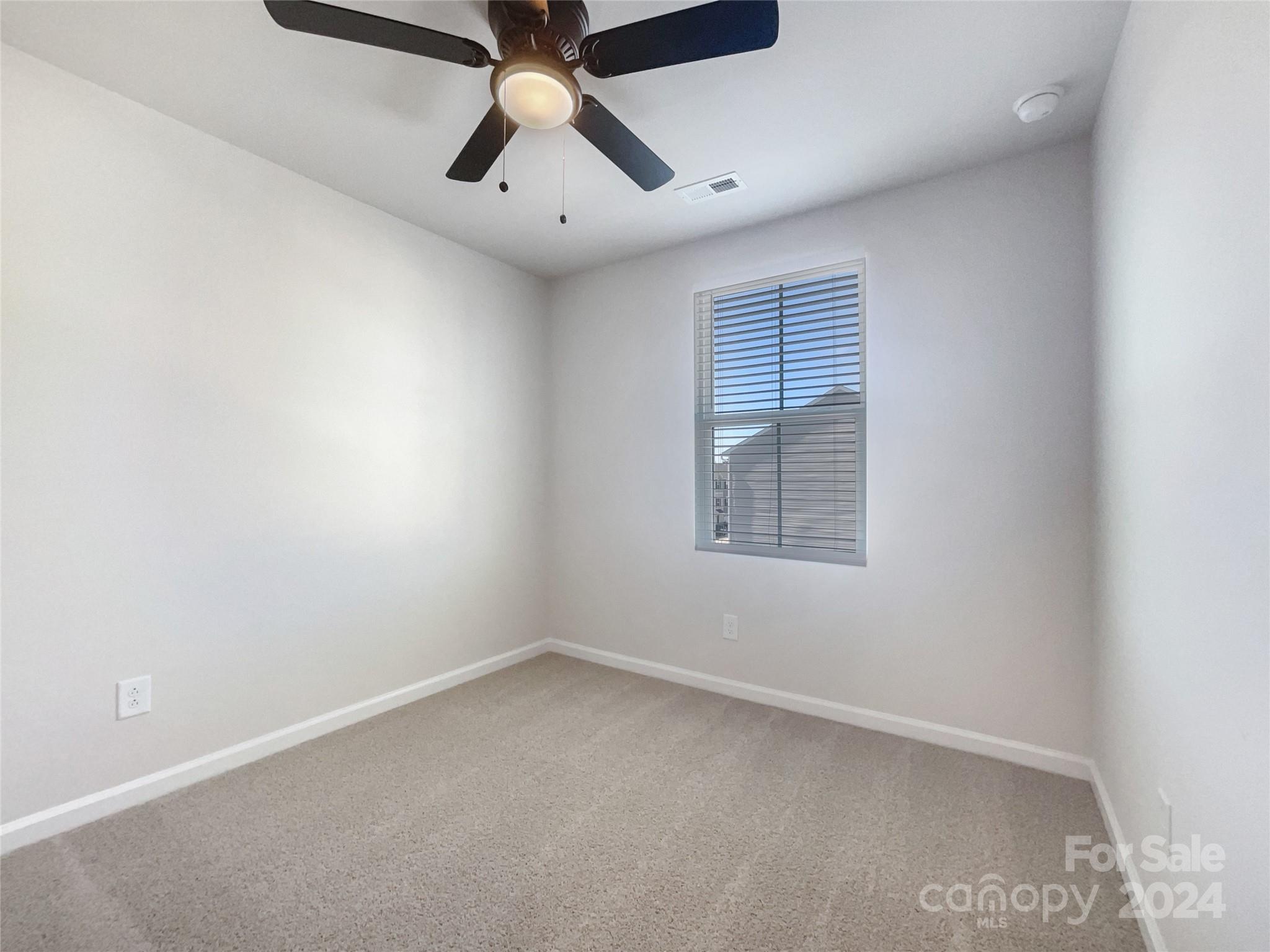708 Dillon Way Fort Mill, SC 29715 - Photo 14 of 19 an empty room with a window and a fan