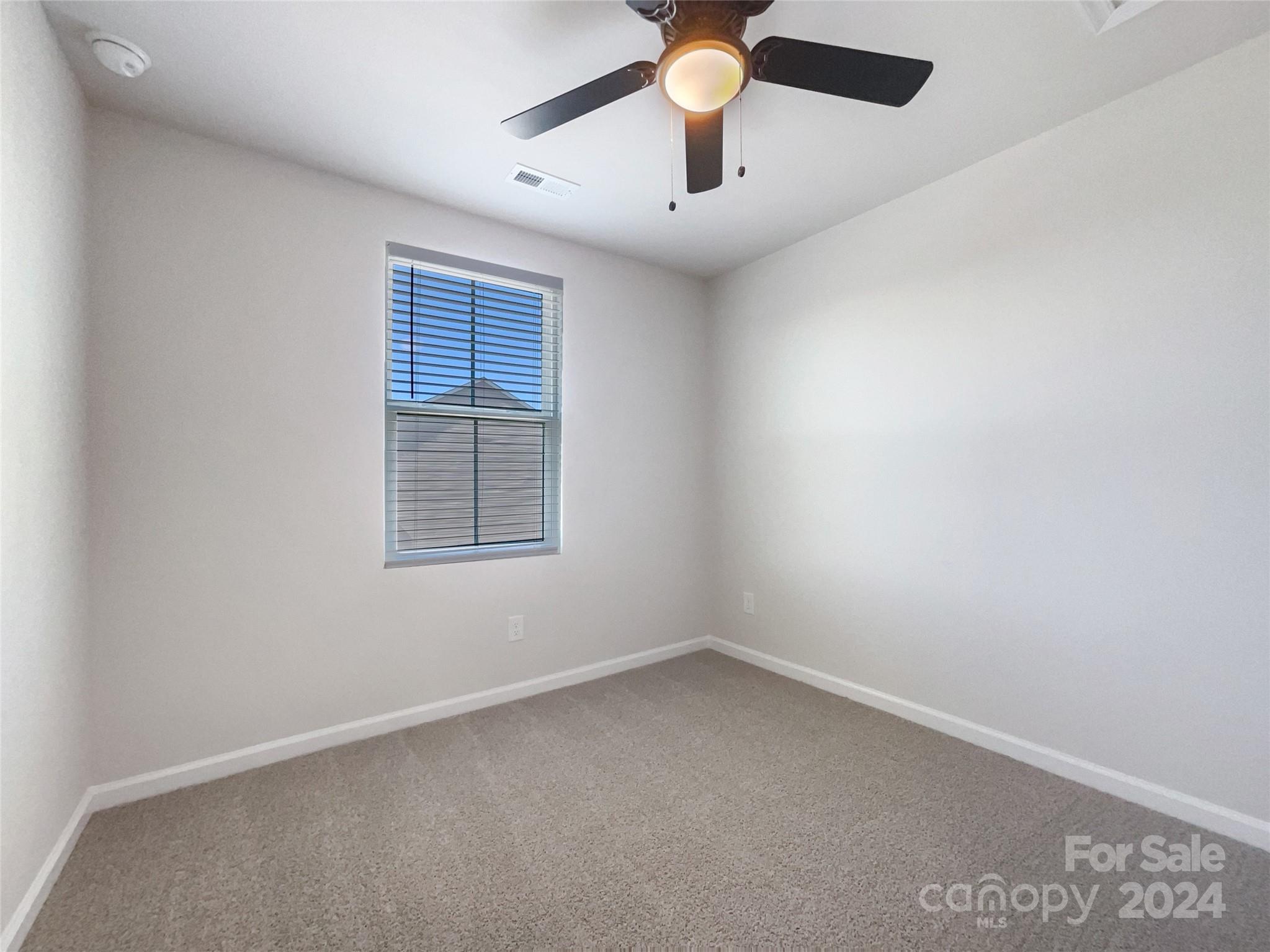 708 Dillon Way Fort Mill, SC 29715 - Photo 15 of 19 an empty room with a window and a fan