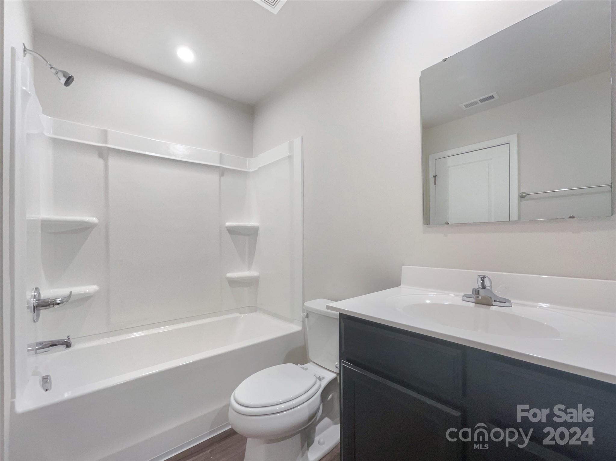 708 Dillon Way Fort Mill, SC 29715 - Photo 18 of 19 a bathroom with a sink mirror toilet and bathtub