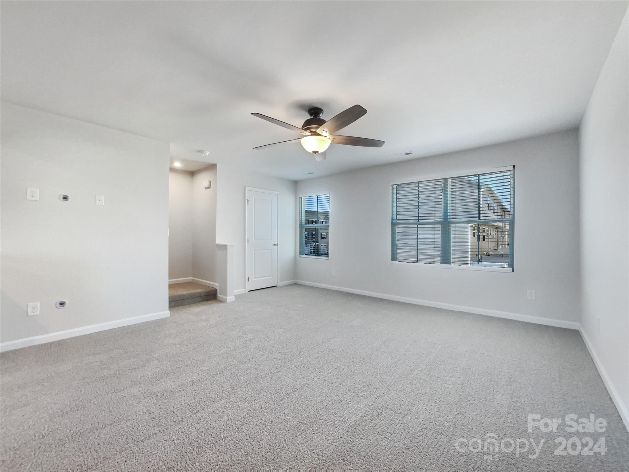 708 Dillon Way Fort Mill, SC 29715 - Photo 3 of 19 an empty room with chandelier fan and windows