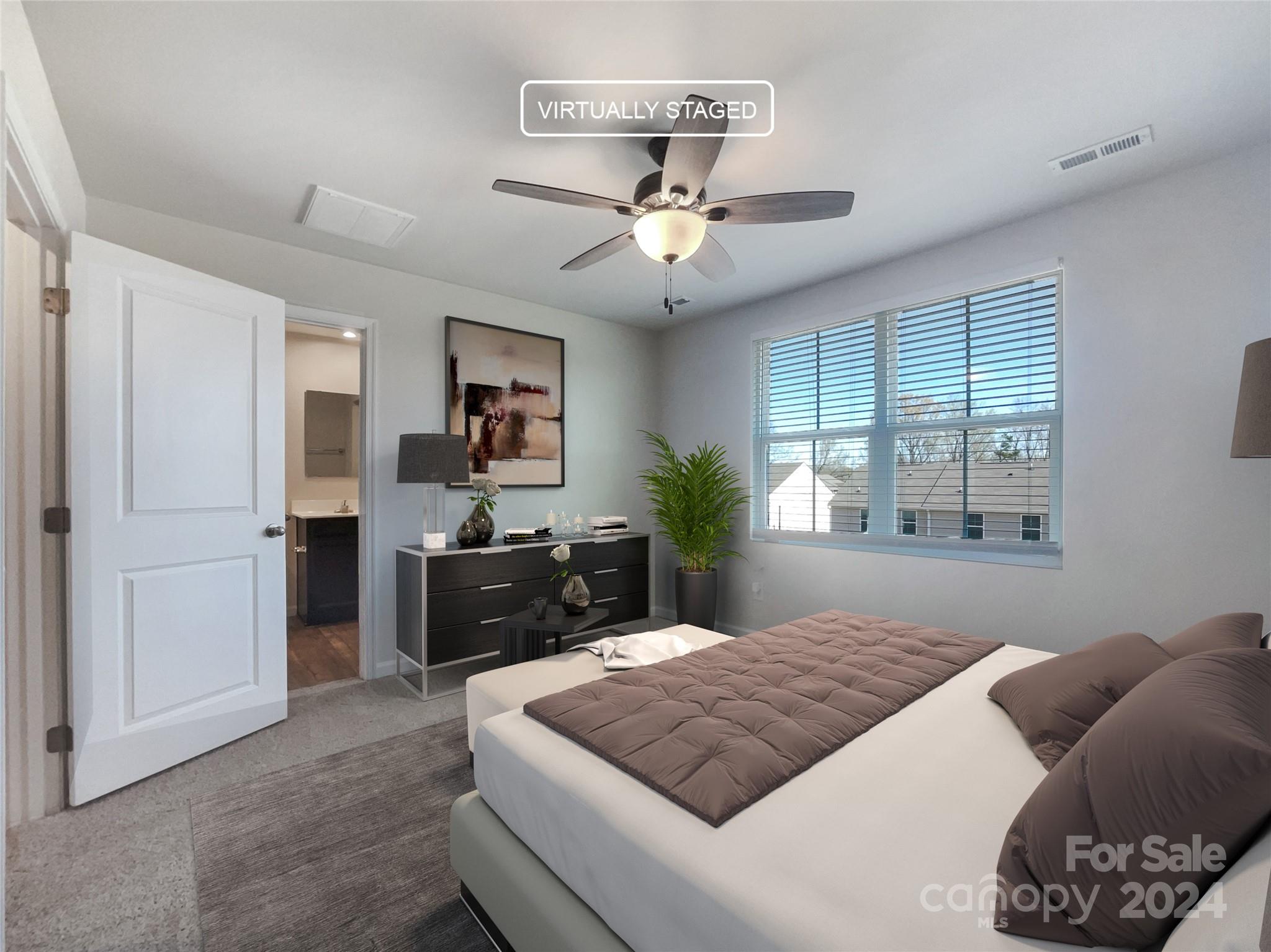 708 Dillon Way Fort Mill, SC 29715 - Photo 4 of 19 a bedroom with a large bed and a chandelier