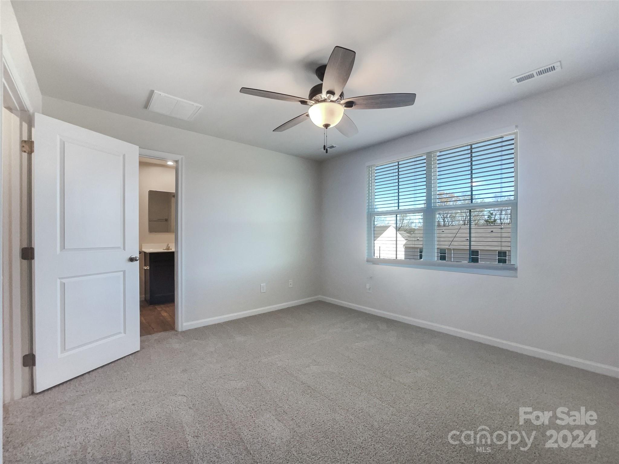 708 Dillon Way Fort Mill, SC 29715 - Photo 5 of 19 an empty room with windows and fan