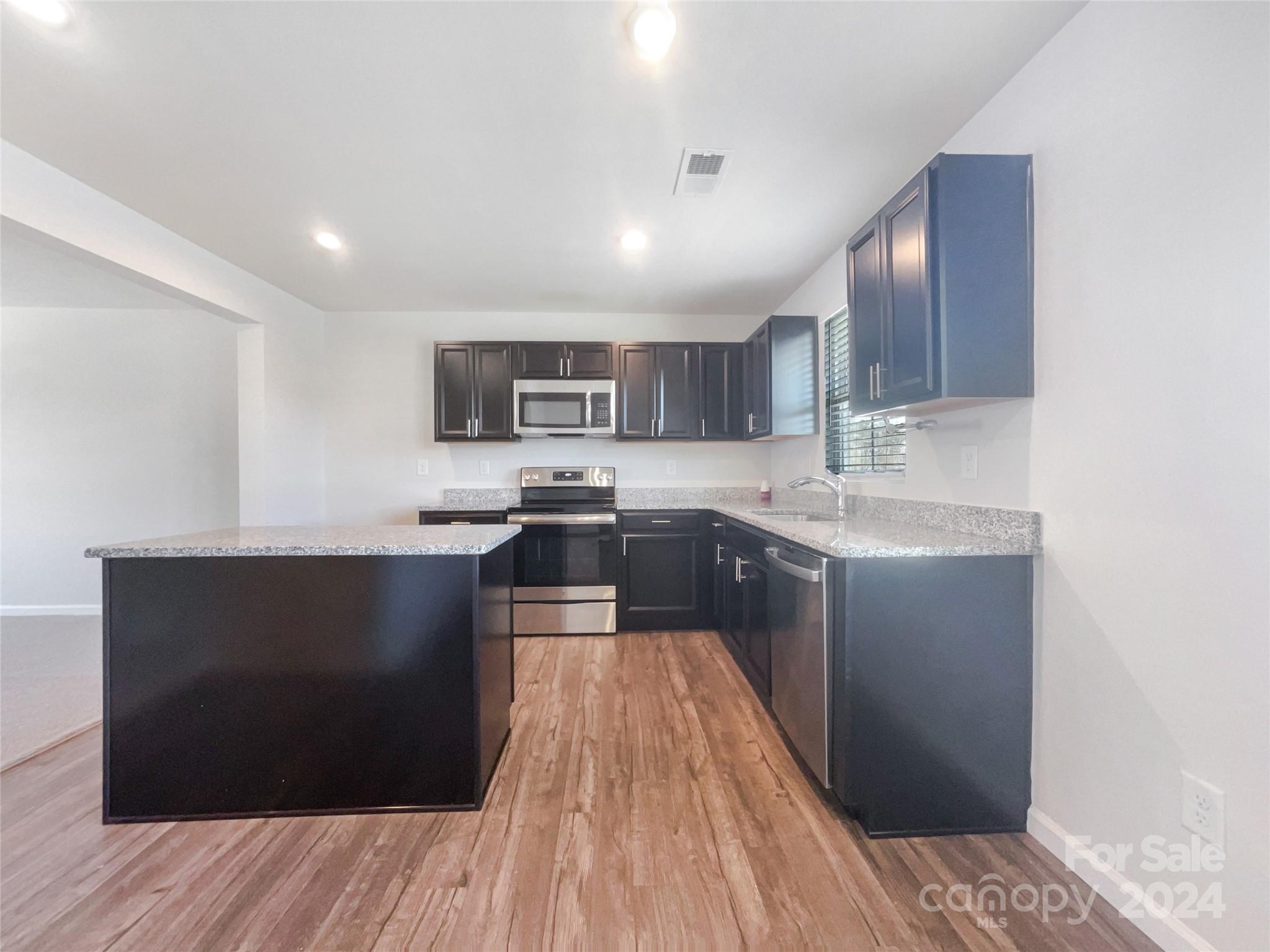 708 Dillon Way Fort Mill, SC 29715 - Photo 6 of 19 a kitchen with a refrigerator and a stove top oven