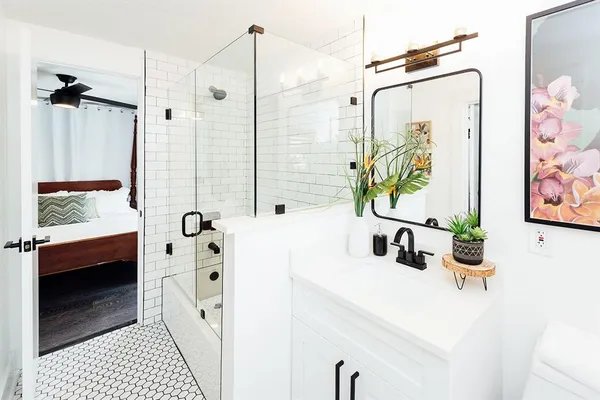 a bedroom with a bed and a window