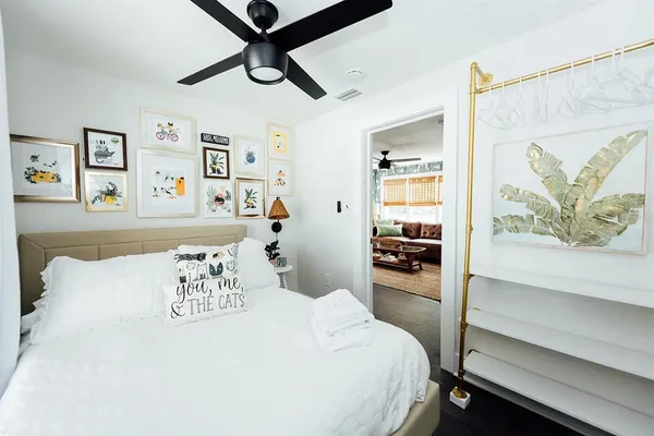 a bedroom with a bed and flat screen tv