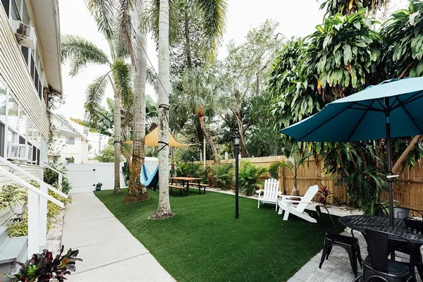 a view of a chair and table in backyard of the house