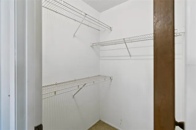 a view of storage and utility room with racks on the wall
