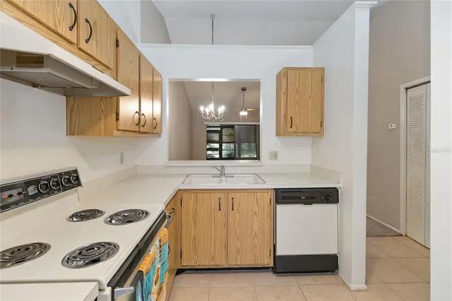 a kitchen with a sink a stove and cabinets