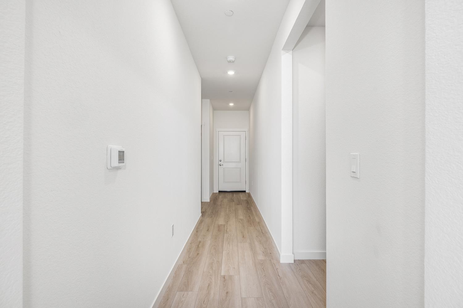 3053 Isley Way Stockton, CA 95212 - Photo 3 of 8 a view of a hallway with wooden floor