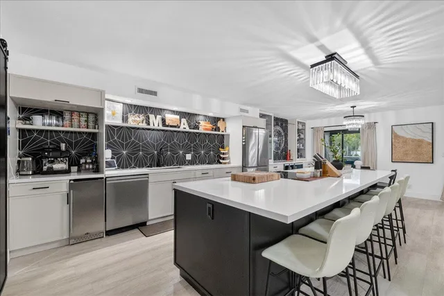 a kitchen with a table chairs and cabinets