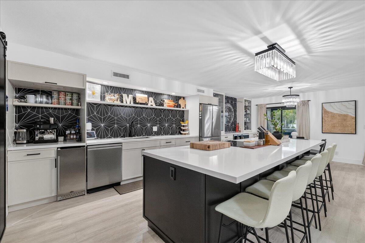 a kitchen with a table chairs and cabinets