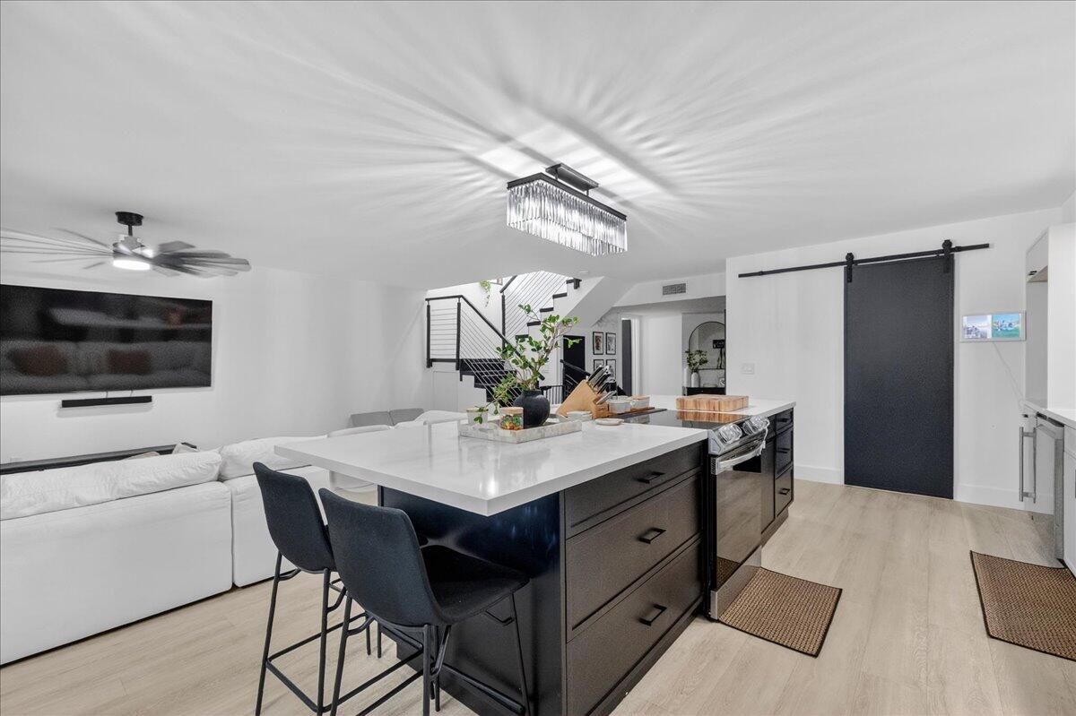 9729 North New River Canal Road, Unit 628 Plantation, FL 33324 - Photo 11 of 50 a kitchen with a sink and refrigerator