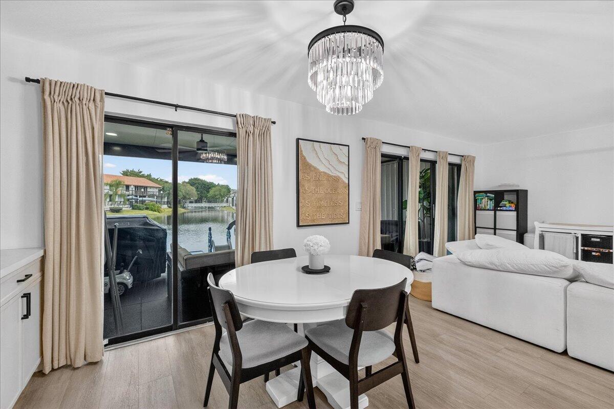 9729 North New River Canal Road, Unit 628 Plantation, FL 33324 - Photo 13 of 50 a view of a dining room with furniture window and wooden floor