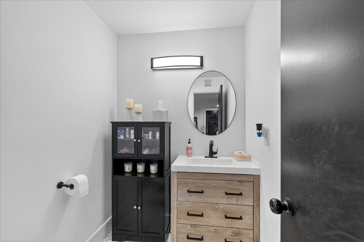 9729 North New River Canal Road, Unit 628 Plantation, FL 33324 - Photo 18 of 50 a bathroom with a sink and a mirror