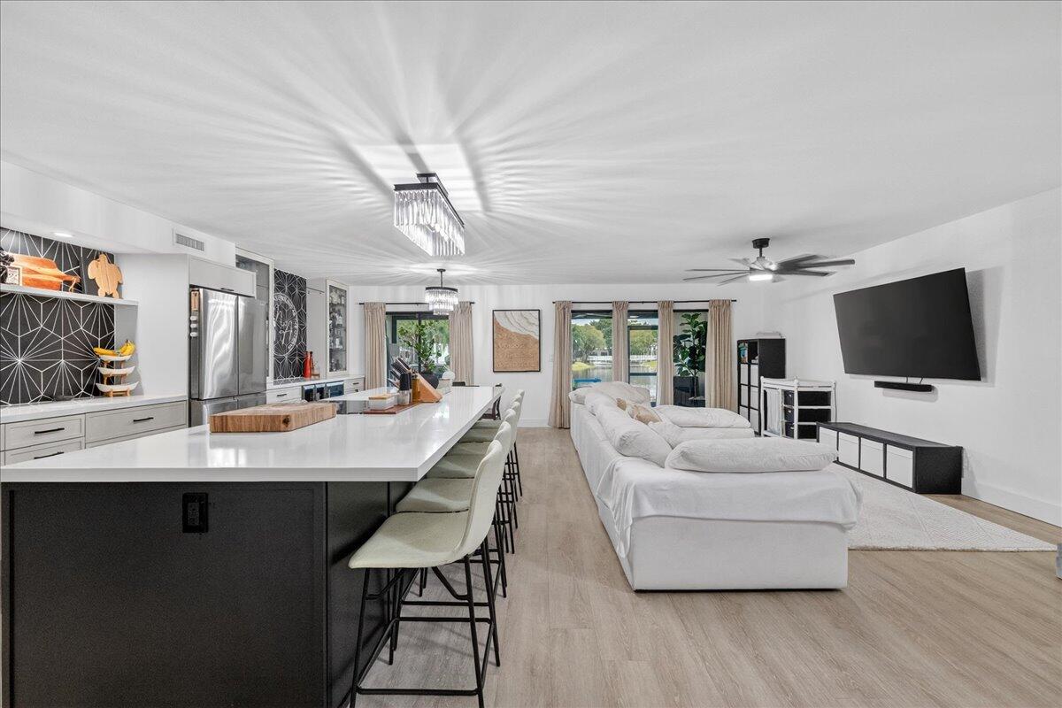 9729 North New River Canal Road, Unit 628 Plantation, FL 33324 - Photo 4 of 50 a living room with furniture and a flat screen tv