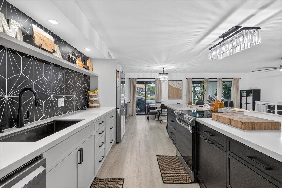 9729 North New River Canal Road, Unit 628 Plantation, FL 33324 - Photo 7 of 50 a kitchen with lots of counter top space and living room