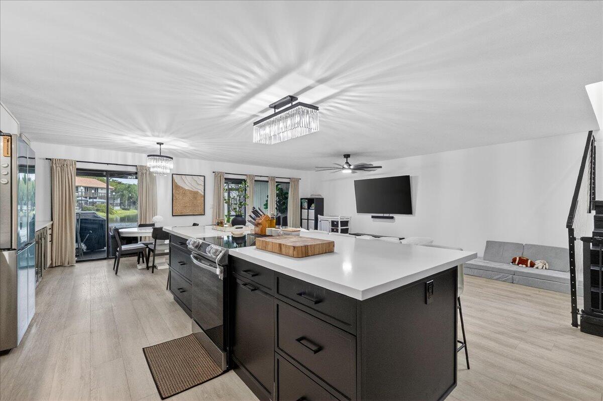 9729 North New River Canal Road, Unit 628 Plantation, FL 33324 - Photo 8 of 50 a kitchen with a sink and wooden floor