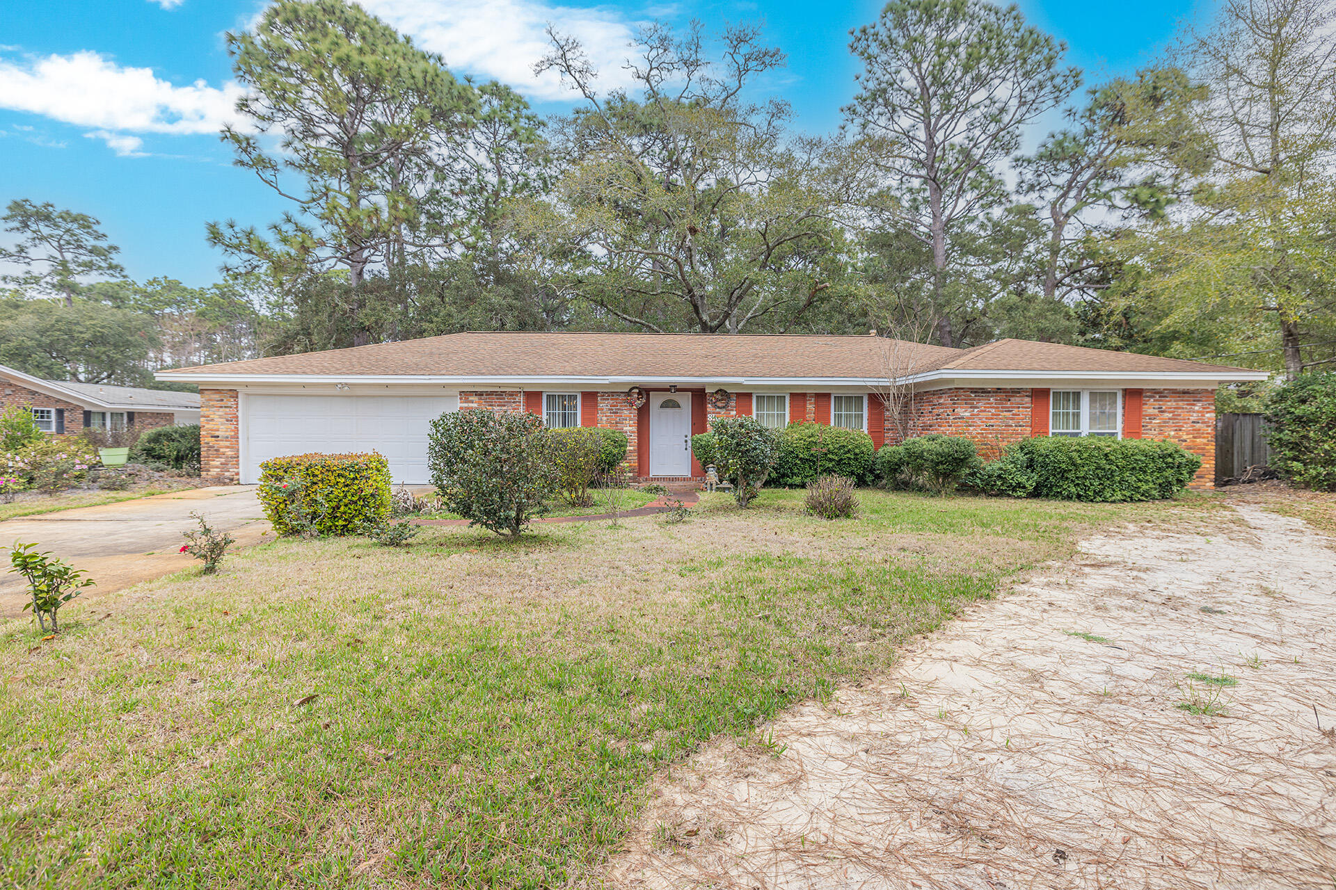 81 Country Club Road Shalimar, FL 32579 - Photo 1 of 31 a house view with a garden space