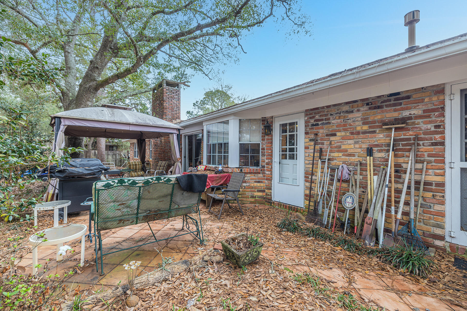 81 Country Club Road Shalimar, FL 32579 - Photo 10 of 31 a view of a house with a patio and wooden fence