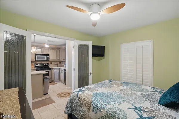 a bedroom with a bed and a television in it