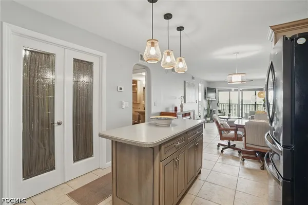 a kitchen with a table chairs and chandelier
