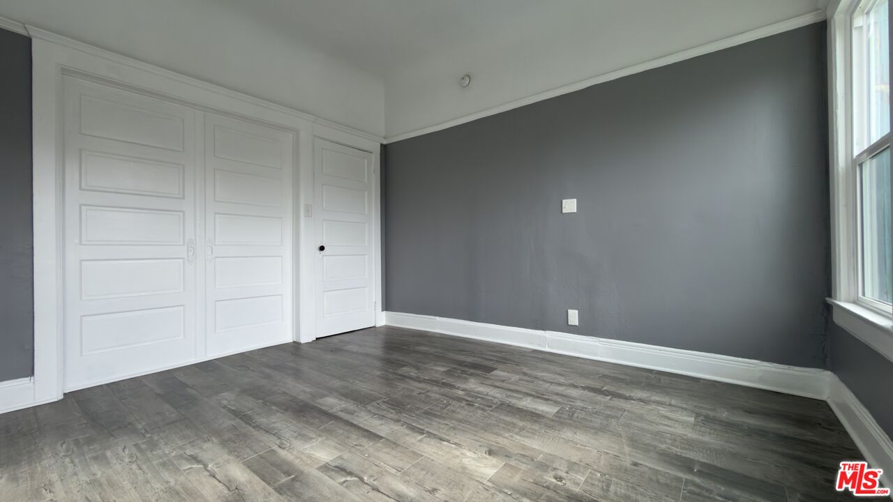 1820 South Highland Avenue, Unit 1820 Los Angeles, CA 90019 - Photo 2 of 11 a view of an empty room with wooden floor