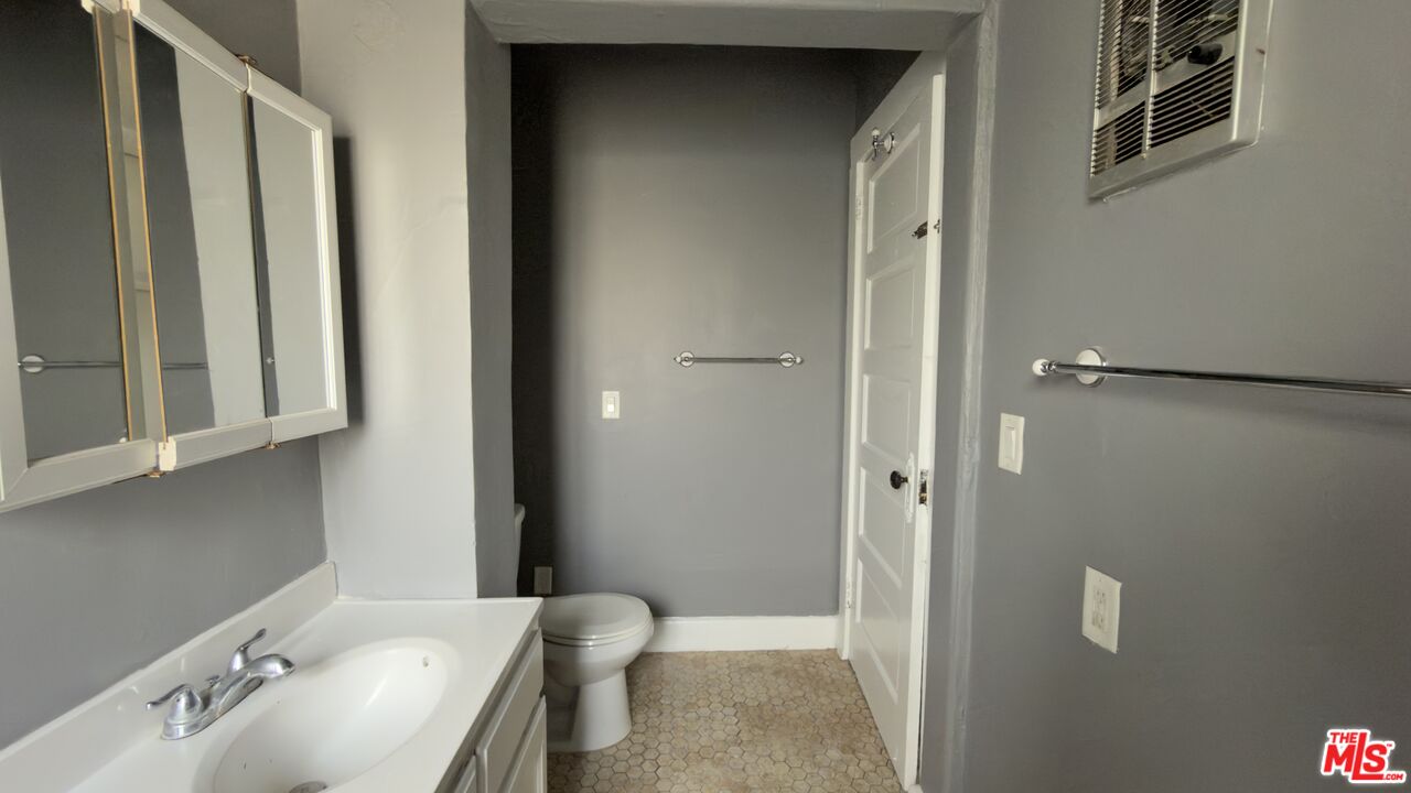 1820 South Highland Avenue, Unit 1820 Los Angeles, CA 90019 - Photo 10 of 11 a bathroom with a sink and a mirror