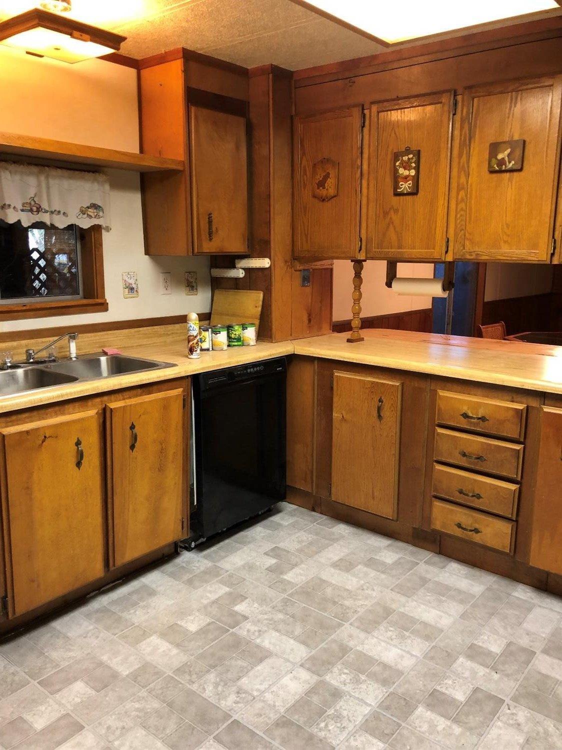6226 East Evans Creek Road, Unit 15 Rogue River, OR 97537 - Photo 18 of 30 a kitchen with stainless steel appliances granite countertop a sink and cabinets