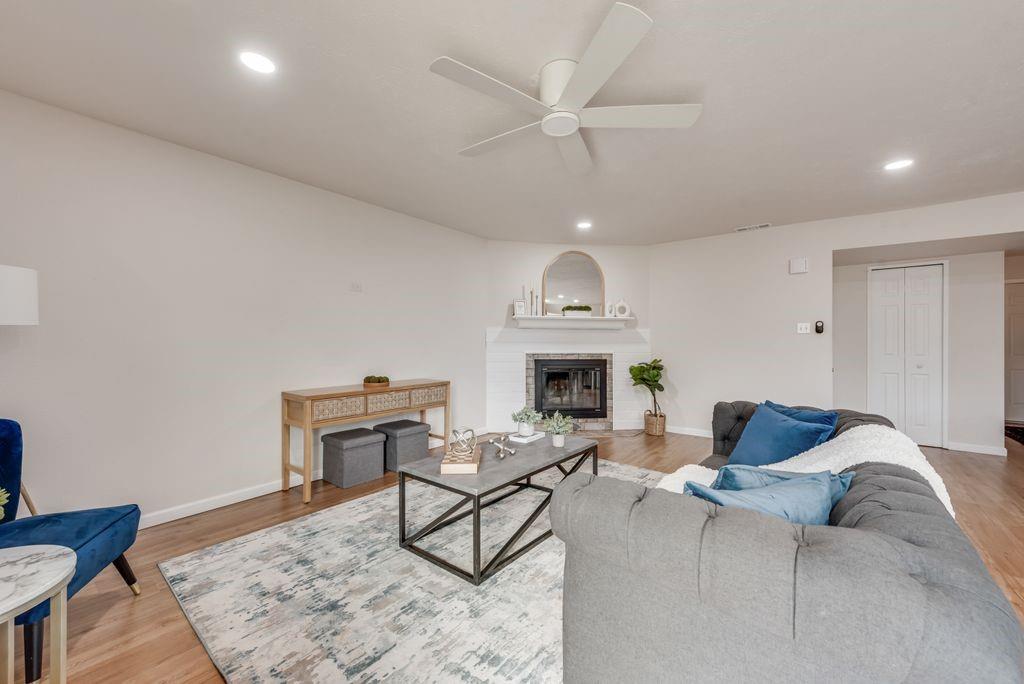 5317 Rutledge Court The Colony, TX 75056 - Photo 11 of 33 a living room with furniture a fireplace and a wooden floor