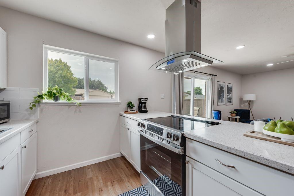5317 Rutledge Court The Colony, TX 75056 - Photo 19 of 33 a kitchen with stainless steel appliances granite countertop a sink stove and cabinets