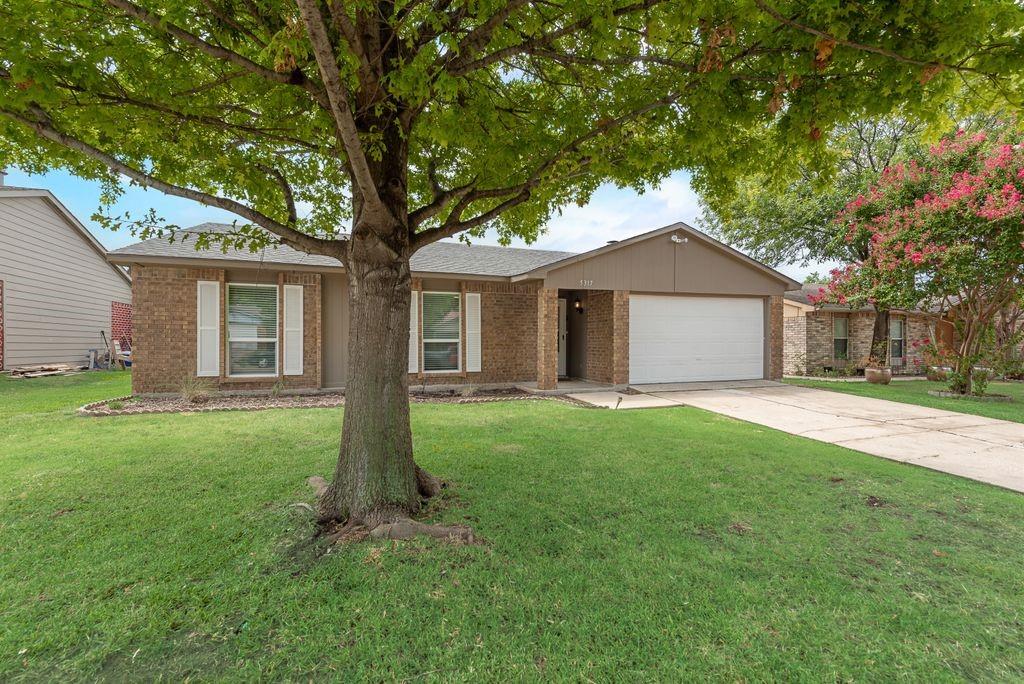 5317 Rutledge Court The Colony, TX 75056 - Photo 2 of 33 a front view of house with yard and green space