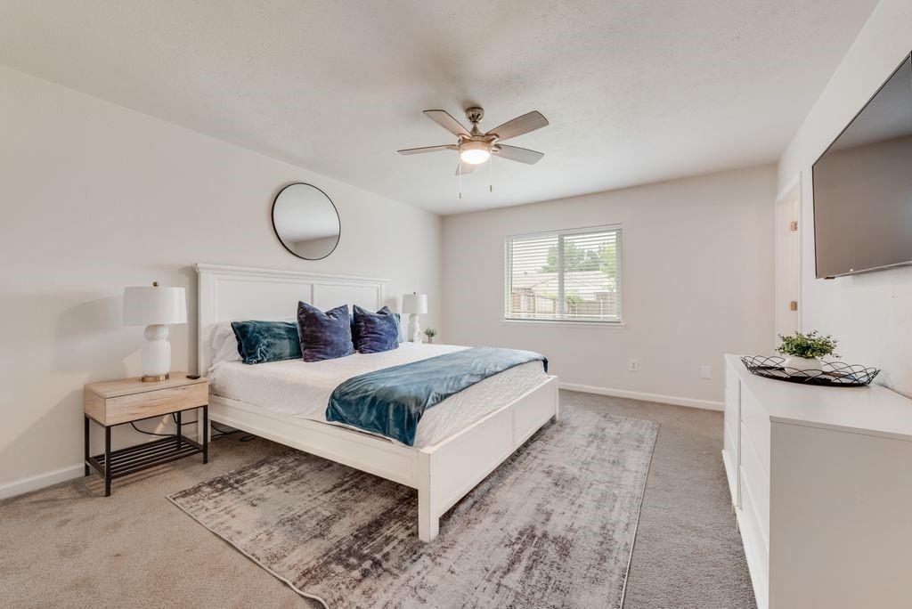 5317 Rutledge Court The Colony, TX 75056 - Photo 22 of 33 a bedroom with a bed and a flat screen tv