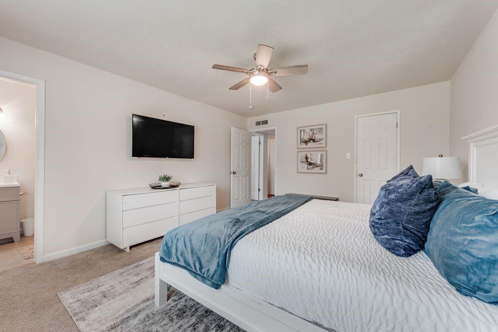 5317 Rutledge Court The Colony, TX 75056 - Photo 23 of 33 a bedroom with a large bed and a flat screen tv