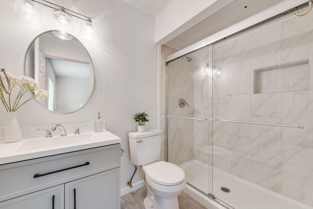 5317 Rutledge Court The Colony, TX 75056 - Photo 24 of 33 a bathroom with a sink toilet and shower