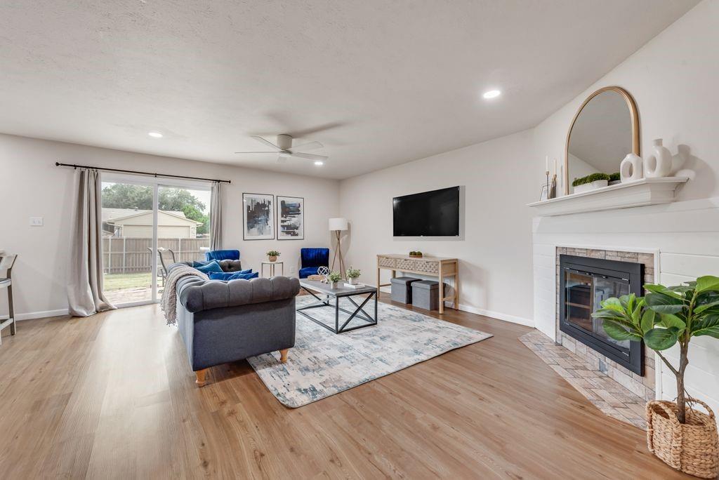 5317 Rutledge Court The Colony, TX 75056 - Photo 10 of 33 a living room with furniture a fireplace and a flat screen tv