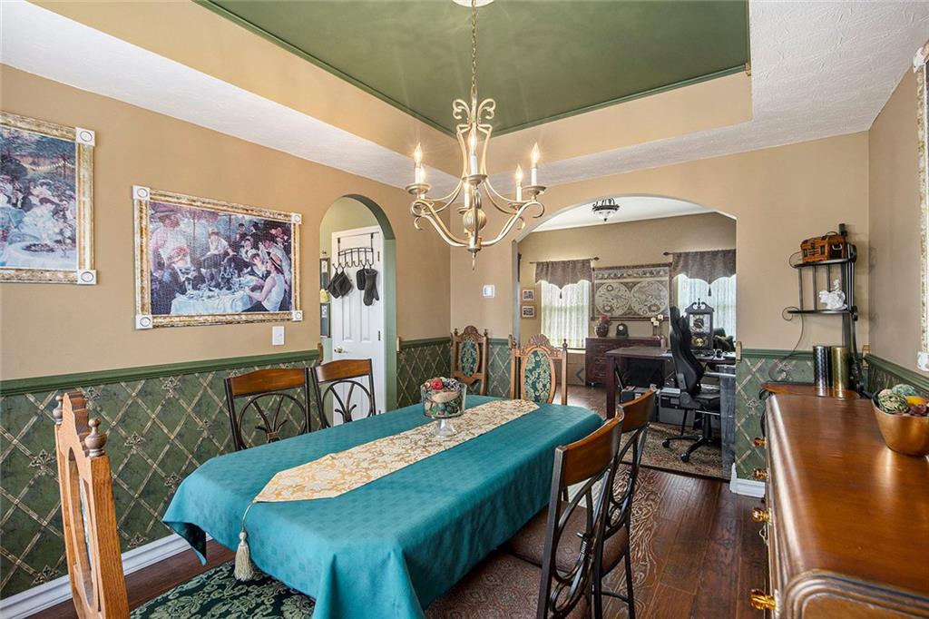 2054 Dartmoth Way Villa Rica, GA 30180 - Photo 13 of 45 a view of a dining room with furniture a chandelier and wooden floor