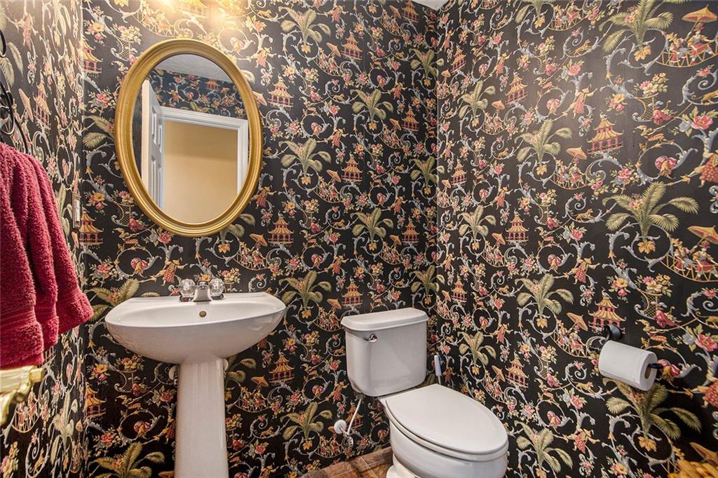 2054 Dartmoth Way Villa Rica, GA 30180 - Photo 16 of 45 a bathroom with a toilet sink and mirror