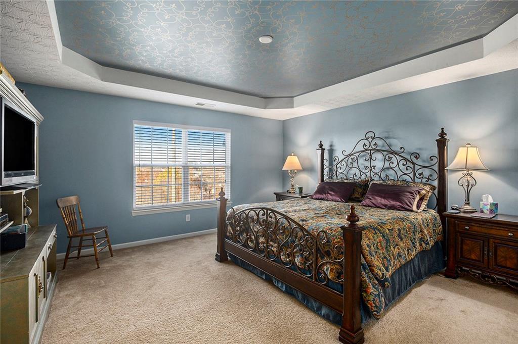 2054 Dartmoth Way Villa Rica, GA 30180 - Photo 18 of 45 a bedroom with a bed and a tv on table