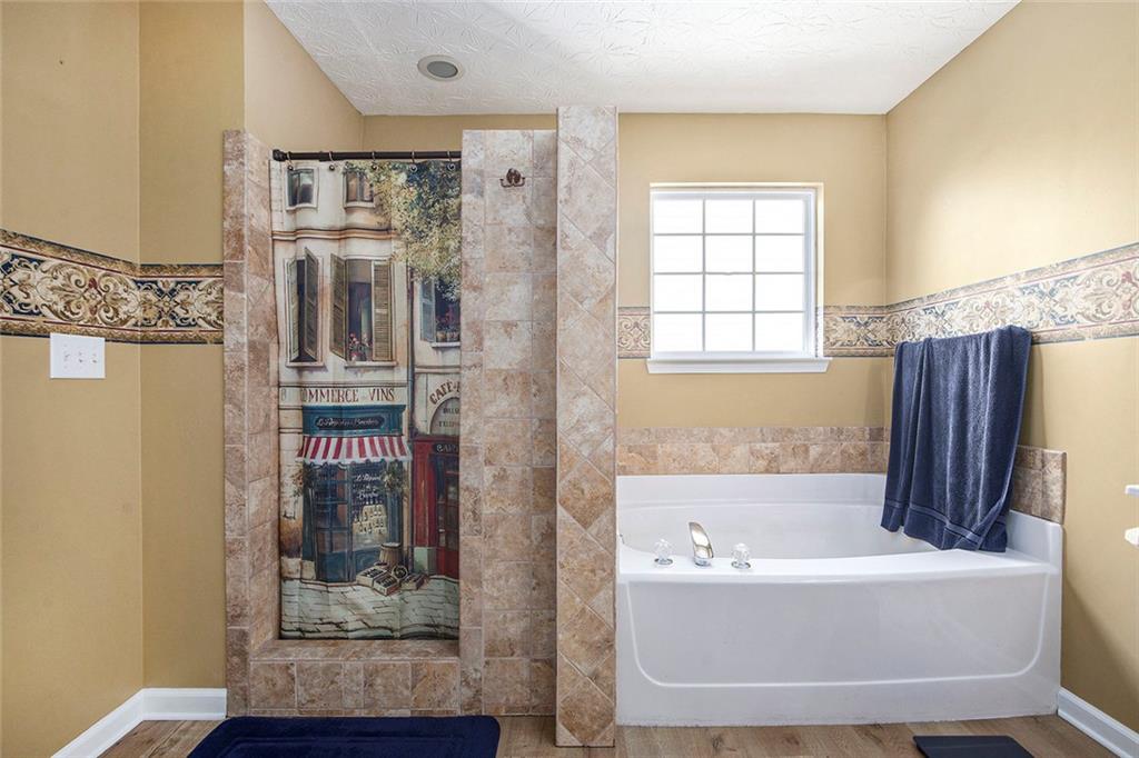 2054 Dartmoth Way Villa Rica, GA 30180 - Photo 23 of 45 a bath tub sitting in a bathroom next to a bathroom