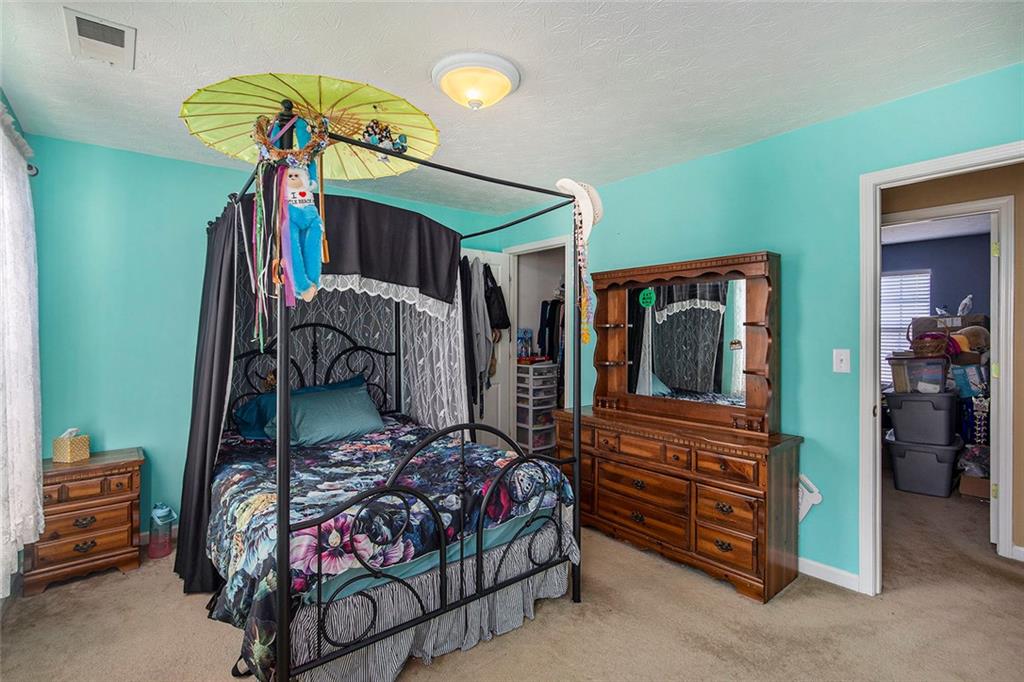 2054 Dartmoth Way Villa Rica, GA 30180 - Photo 26 of 45 a bedroom with a bed and a chandelier