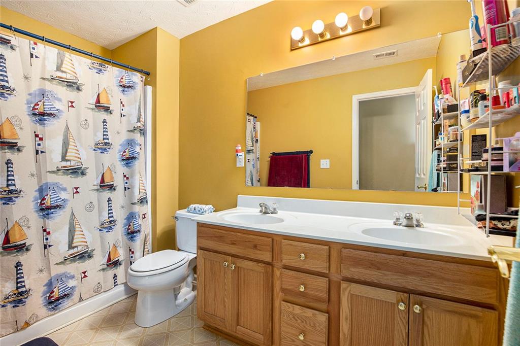 2054 Dartmoth Way Villa Rica, GA 30180 - Photo 27 of 45 a bathroom with a sink toilet and shower