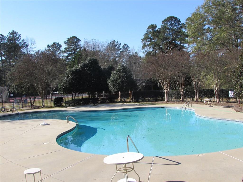 2054 Dartmoth Way Villa Rica, GA 30180 - Photo 41 of 45 a swimming pool with outdoor seating and yard