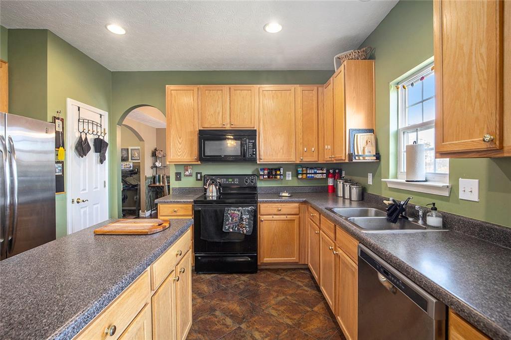2054 Dartmoth Way Villa Rica, GA 30180 - Photo 10 of 45 a kitchen with stainless steel appliances granite countertop a sink a stove and a refrigerator