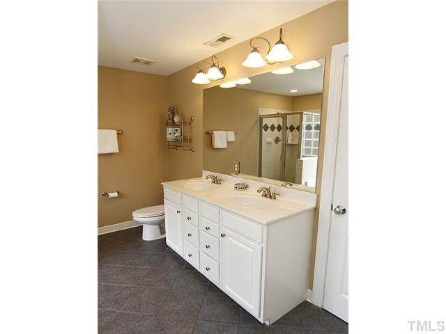 131 Forbes Road Wake Forest, NC 27587 - Photo 8 of 20 The master bath features tile flooring, double vanities, and upgraded plumbing fixtures.